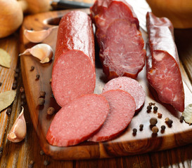 Sausage and spices on a brown table