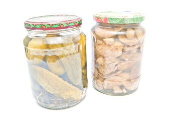 two jars with marinated vegetables on white