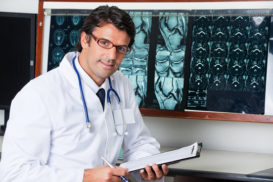 Radiologist At Desk With Clipboard