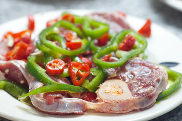 steak with red and green peppers on a plate