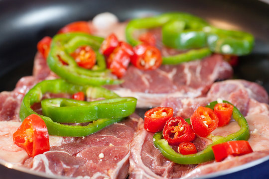 steak with red and green peppers in a pan