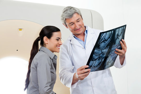 Radiologist Showing X-ray Report To Patient