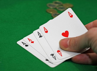 Obraz premium hand with poker of aces on a table game