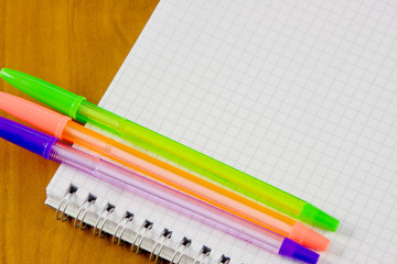 Obraz premium school belonging, notebook and three pens