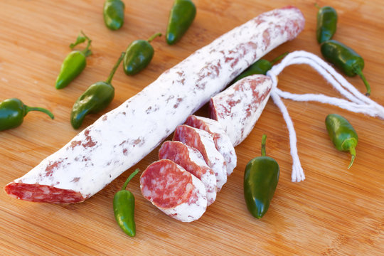 Spanish fuet sausages with green peppers