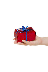 Holiday gift in bright red packaging on a female hand isolated