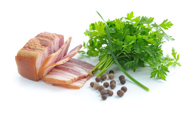 Pieces of bacon are with the bunch of green parsley