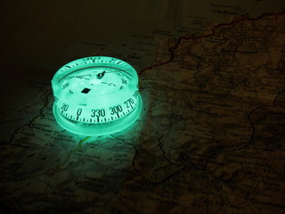 Glowing compass on a map