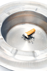 Cigarette butt in a metal ashtray