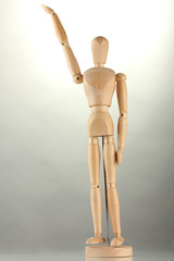 wooden mannequin, on grey background