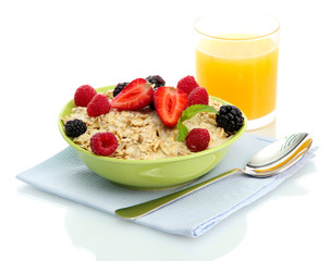 tasty oatmeal with berries and glass of juice, isolated on