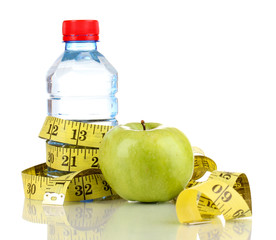 Bottle of water, apple and measuring tape isolated on white