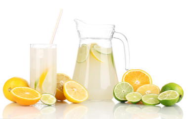 Citrus lemonade in pitcher and glass of citrus around isolated