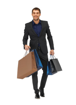 Handsome Man In Suit With Shopping Bags