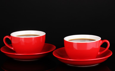 A red cups of strong coffee isolated on black