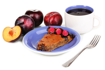 Tasty pie on blue plate with plums isolated on white