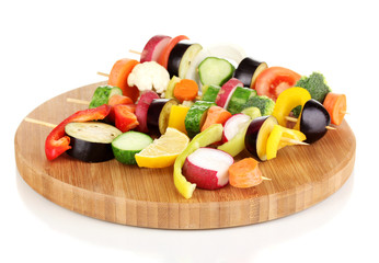 Sliced vegetables on wooden picks isolated on white