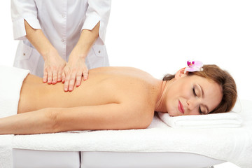 Fototapeta na wymiar beautiful woman in spa salon getting massage, isolated on