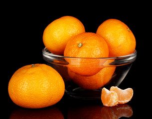 Tasty mandarines in bowl isolated on black