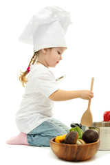 little girl in chef's hat with pan and vegetables, isolated