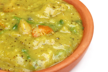 Bengali cuisine – Mashkalai dal with shrimp on a clay pottery