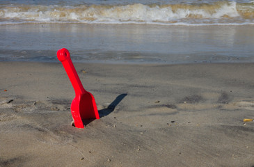 Red shovel at the beach