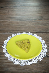 Pistachio cake on wooden background