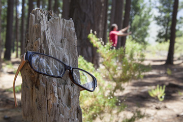 man looking for his spectacles in the woods