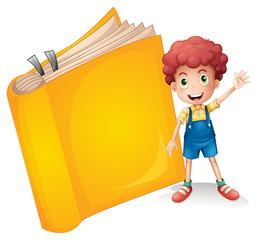 A smiling boy and a yellow book