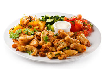 Grilled meat and vegetables on white background