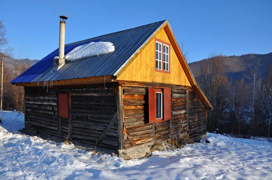 Small cabin in the mountains at winter