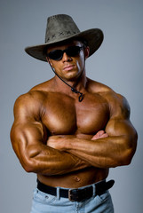 Muscular male in a hat and sunglasses