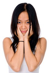 Naklejka premium Beautiful Vietnamese girl with her hands on her cheeks