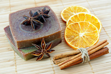 Obraz na płótnie Canvas Hand-made soap with orange and cinnamon sticks