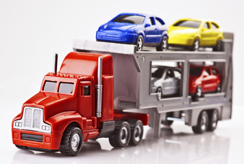 Toy cars transported on a truck plastic