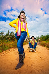 Funny couple are sledding at summer