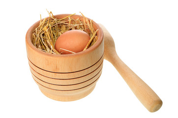 Fototapeta premium mortar with egg placed in straw isolated on white background