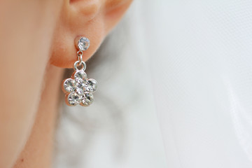 Earring with diamond. Woman with earring close up - obrazy, fototapety, plakaty