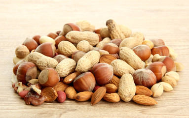 assortment of tasty nuts on wooden background