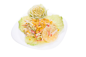 Mixed salad with white dressing served pretty on a large plate