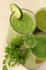 Three kinds of green juice on light background