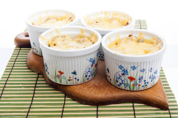 Julienne with hen and mushrooms covered with much cheese