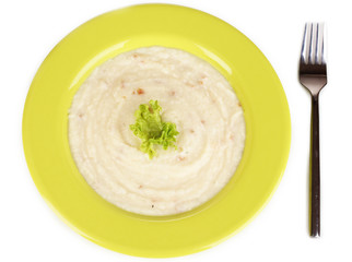 Mashed potatoes in green plate isolated on white