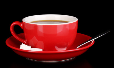 A red cup of strong coffee isolated on black
