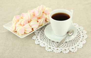 Marshmallows on plate on light background