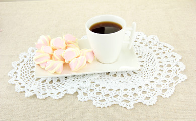 Marshmallows on plate on light background