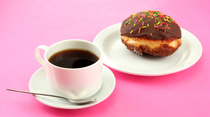Tasty donuts on color plate on color background