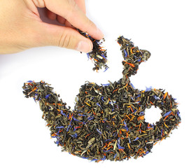 hand, putting a pinch of tea in teapot