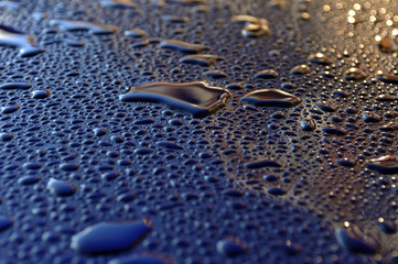 Water drops after heavy rain on the metallic background