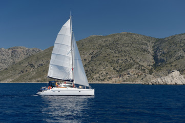 Fototapeta na wymiar Sailing yacht around the beautiful island